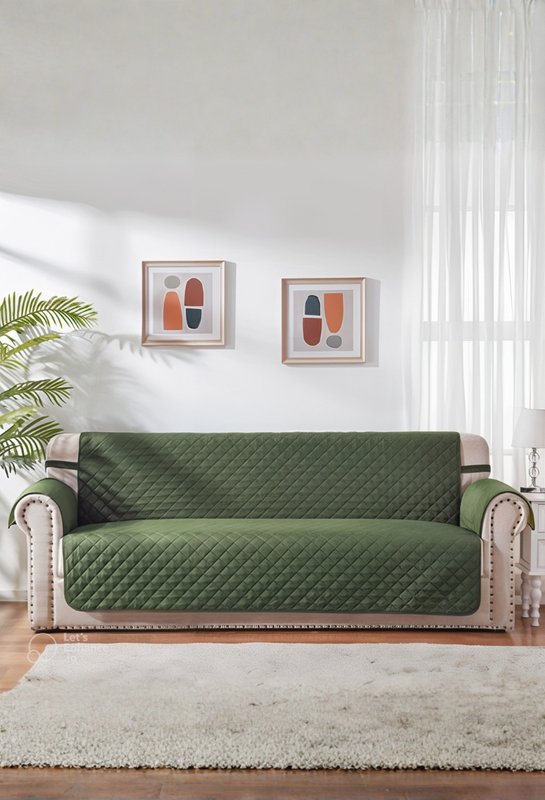 Green sofa cover on a couch in a living room with decor elements.